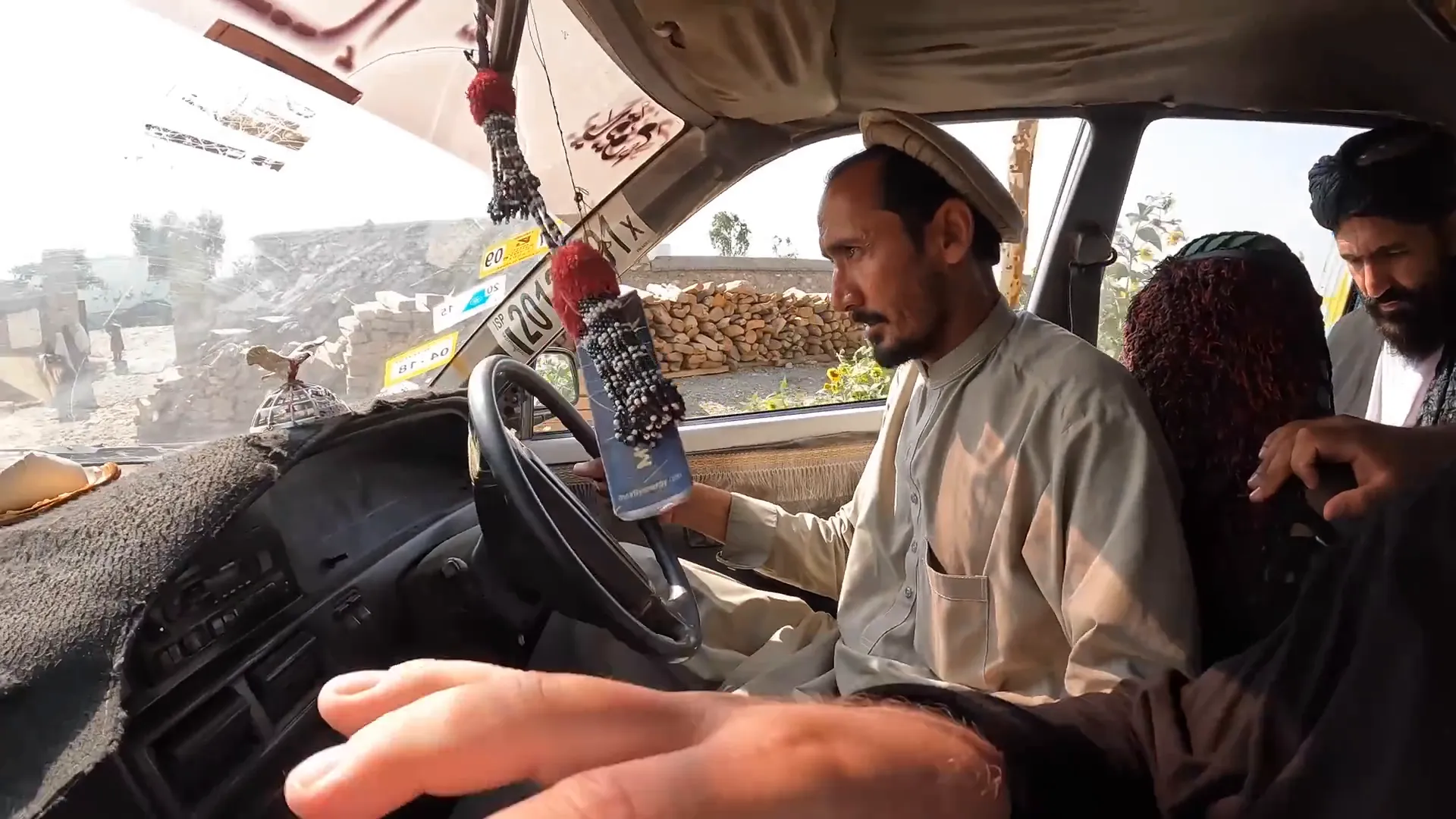 Vehicle packed with passengers and a security guard at the start of the Tora Bora road
