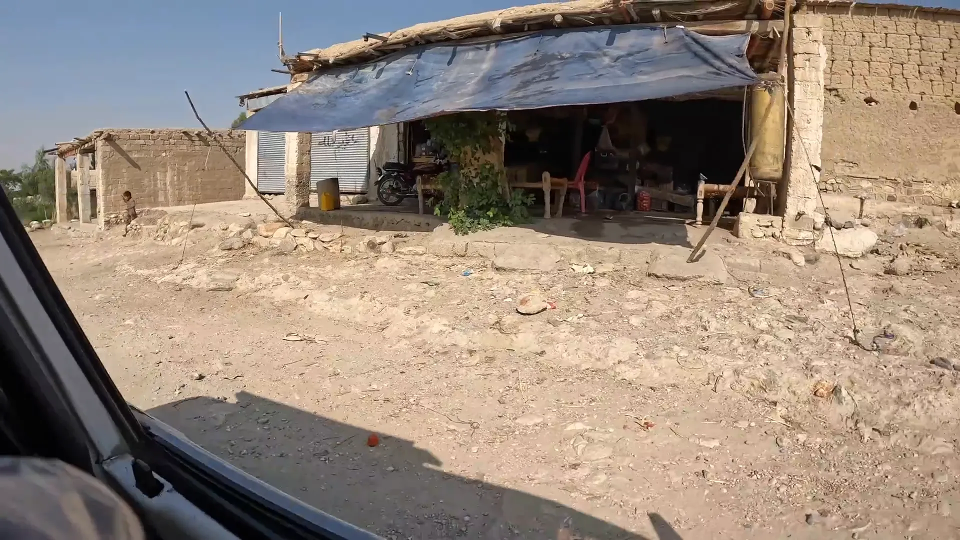 Giving balls to children beside a dirt road in eastern Afghanistan