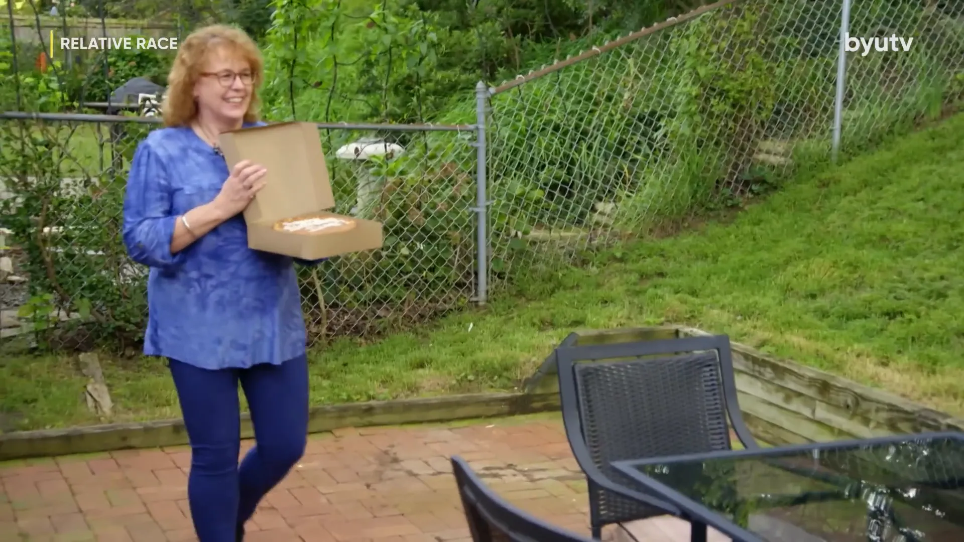 The cake delivery arrives—Sharon appears, surprising Dennis on his birthday.