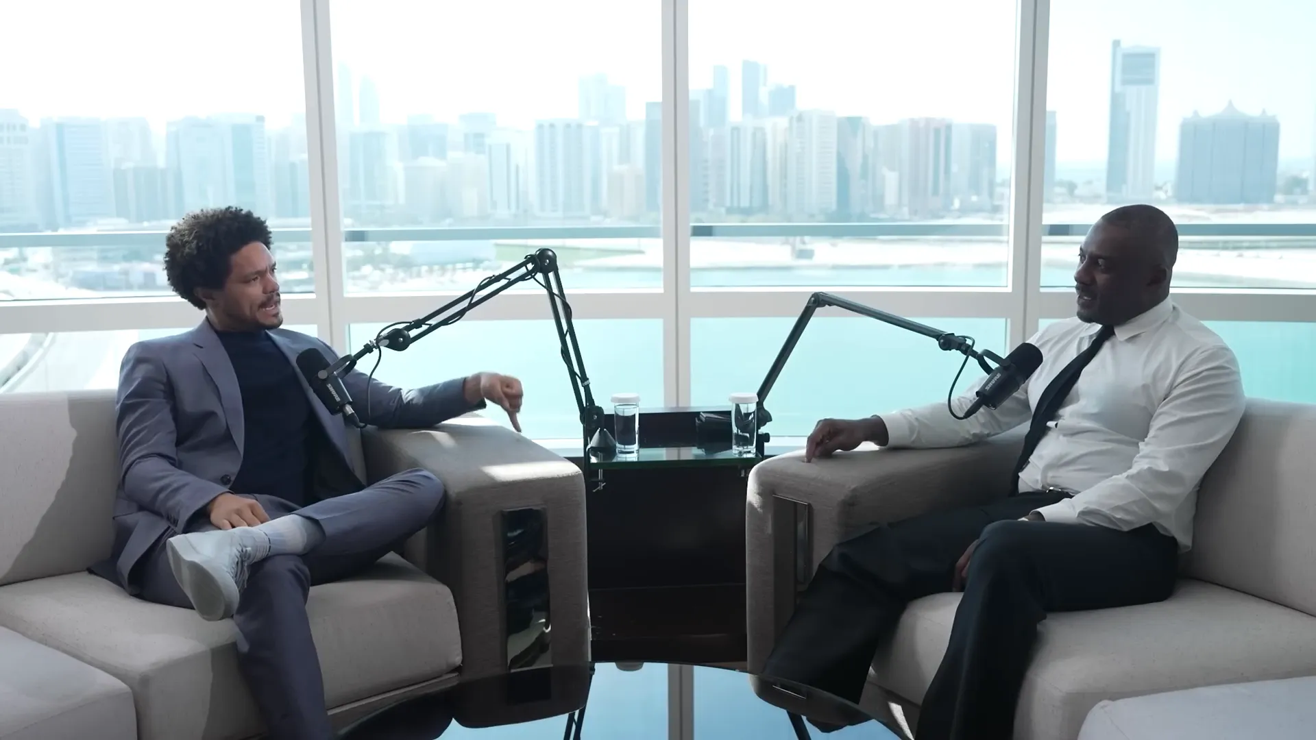 Trevor and Idris greeting each other in the Abu Dhabi hotel room