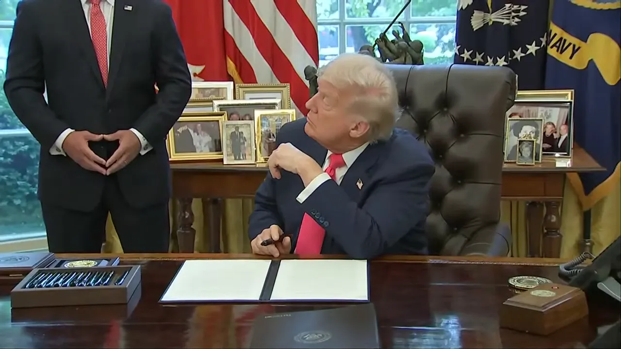 President Trump signing the proclamation in the Oval Office