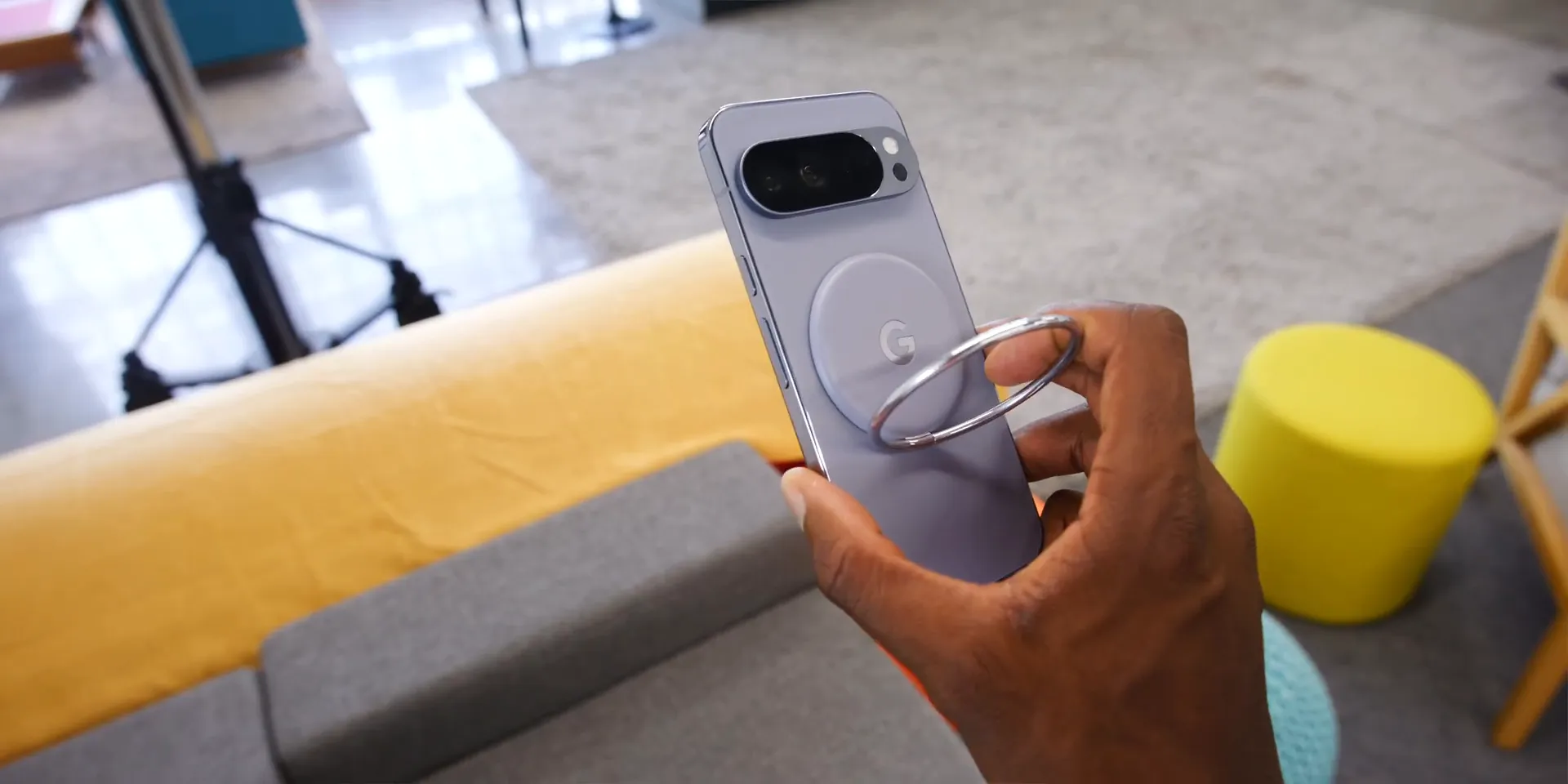 Pixel Snap accessories: magnetic chargers and Pixel Ring Stand attached to phone