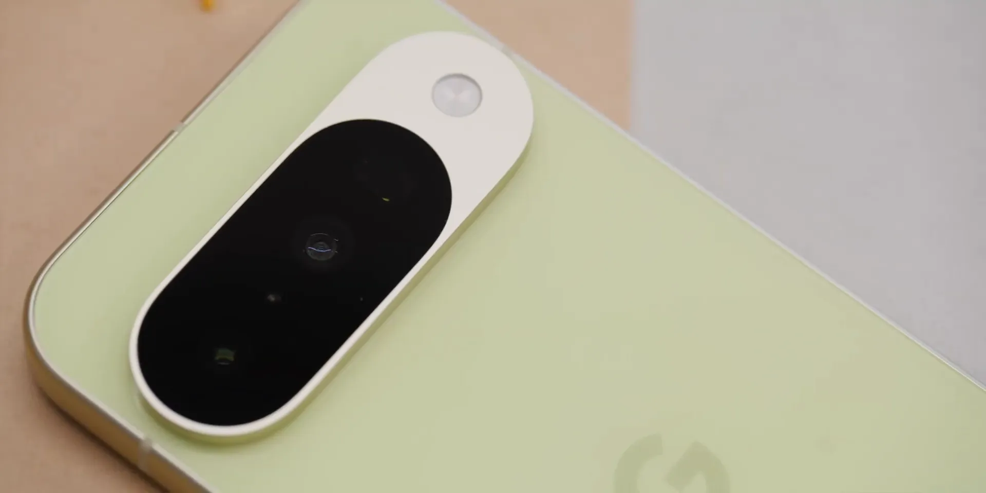 Matched metal speaker grills on Pixel 10, close-up detail