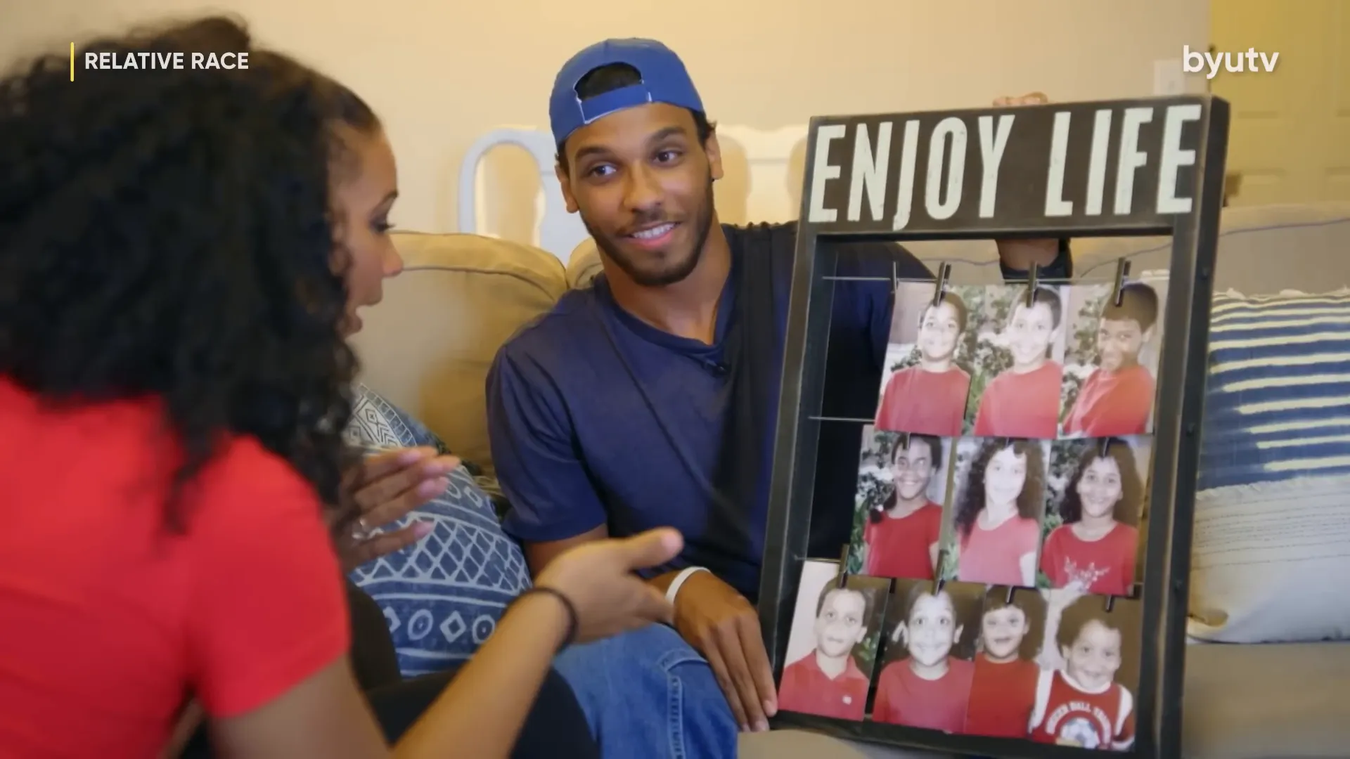 The large framed family photo with all siblings smiling, each wearing red.