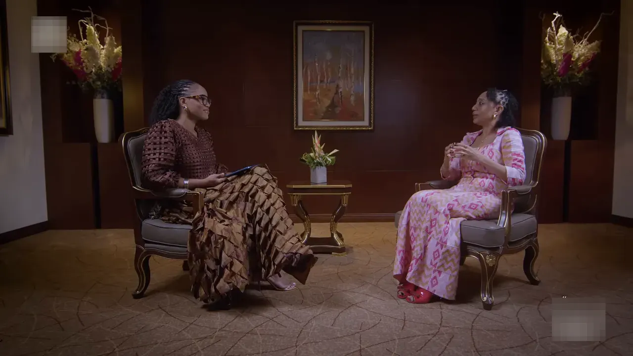 Wide shot of the interviewer and Samia during a key moment discussing continental unity