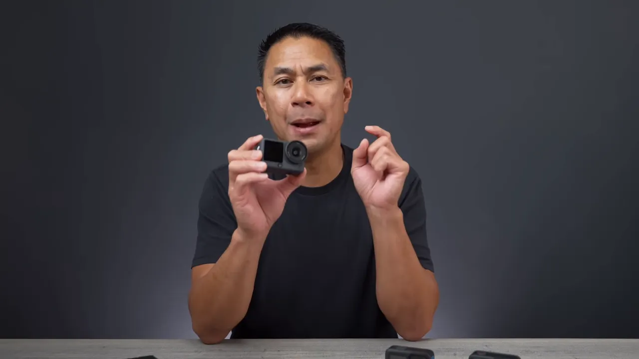 Presenter holding DJI Osmo Action 6 toward the camera showing the lens and front screen