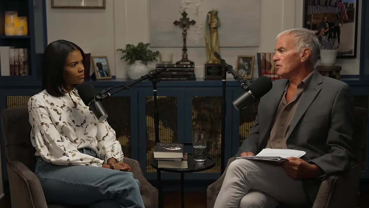 Two people seated in a studio facing each other with microphones between them during an interview