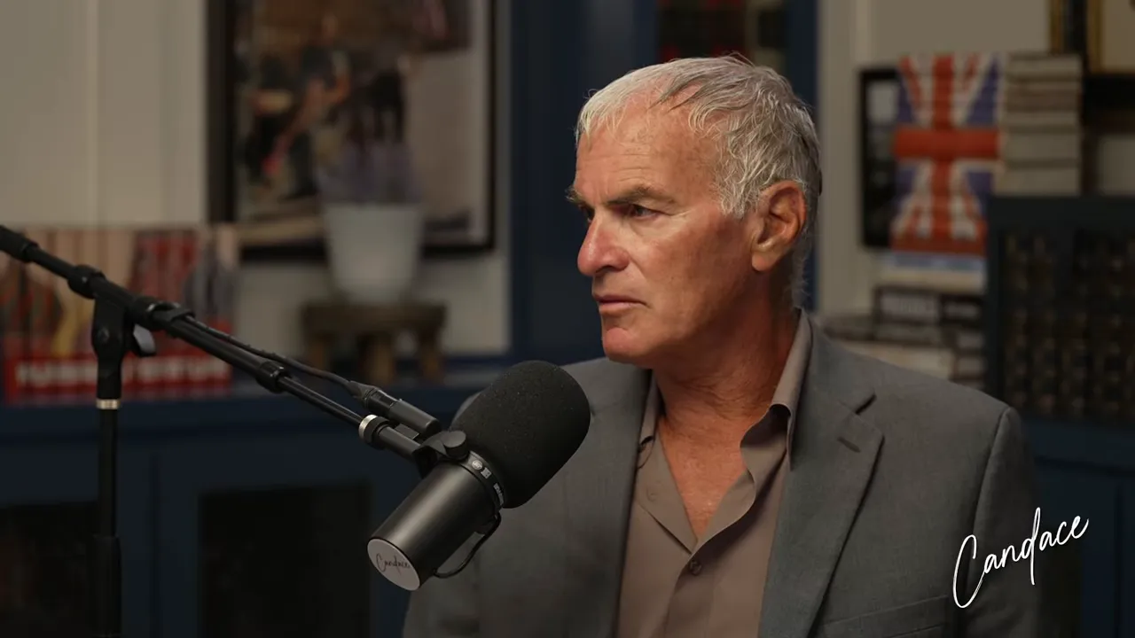 Studio interview: guest looking attentive while speaking into a professional microphone, bookshelf backdrop