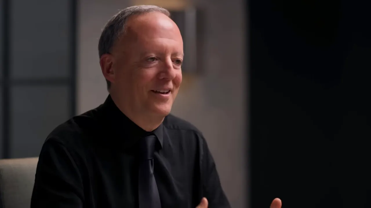 Interview guest talking and gesturing with hands in a studio interview