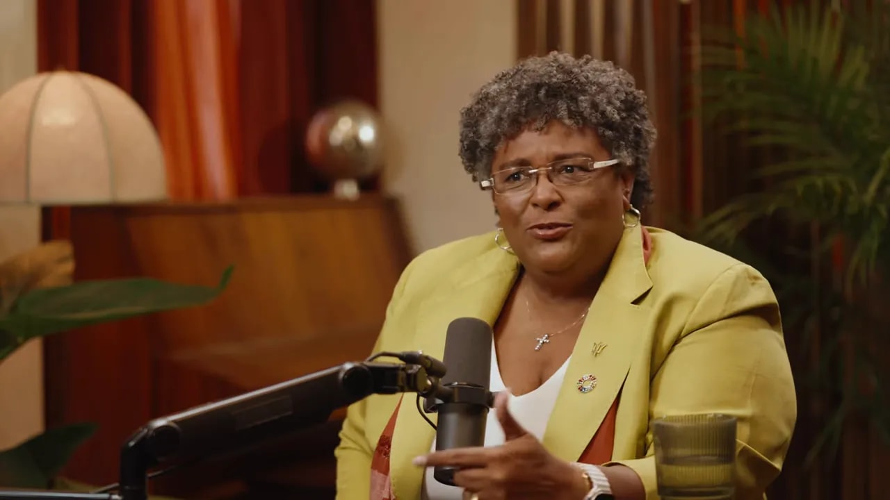 Interview guest explaining a point in the studio, expressive while speaking into a microphone