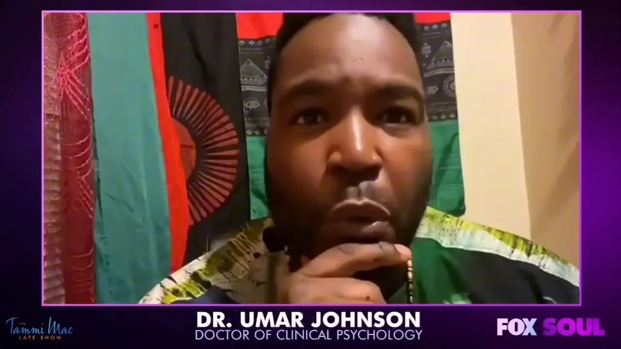 Panel guest speaking directly to camera with a focused expression discussing systemic issues