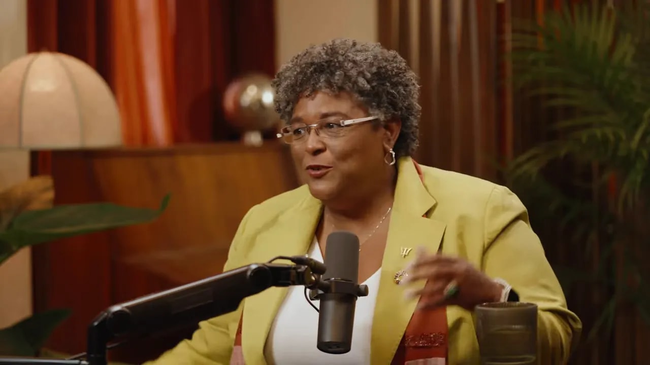 Interview guest animatedly gesturing while speaking into a microphone