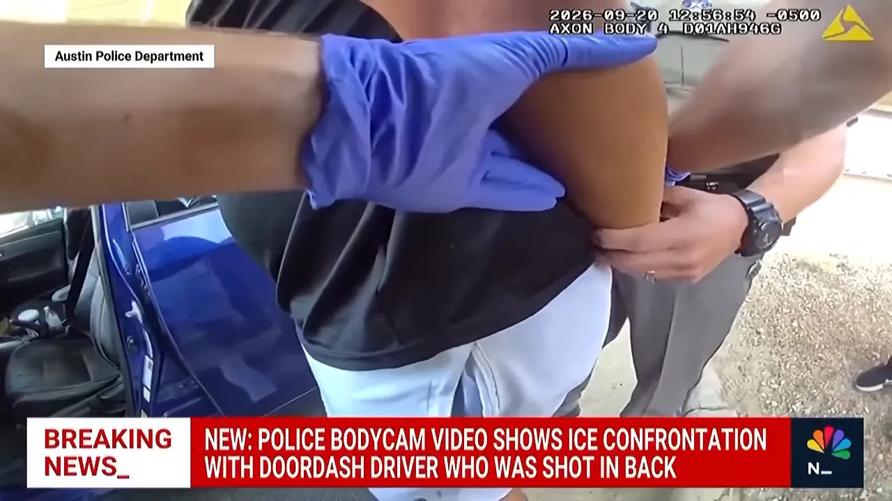 Austin police body camera footage showing an injured man seated in a blue car as officers assist him