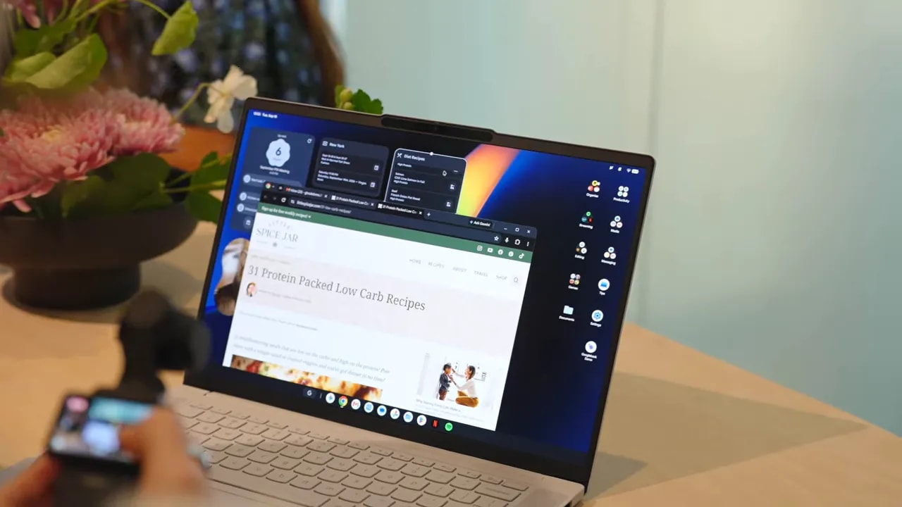 White HP Googlebook 14 on a table with a dark desktop interface and application windows on screen