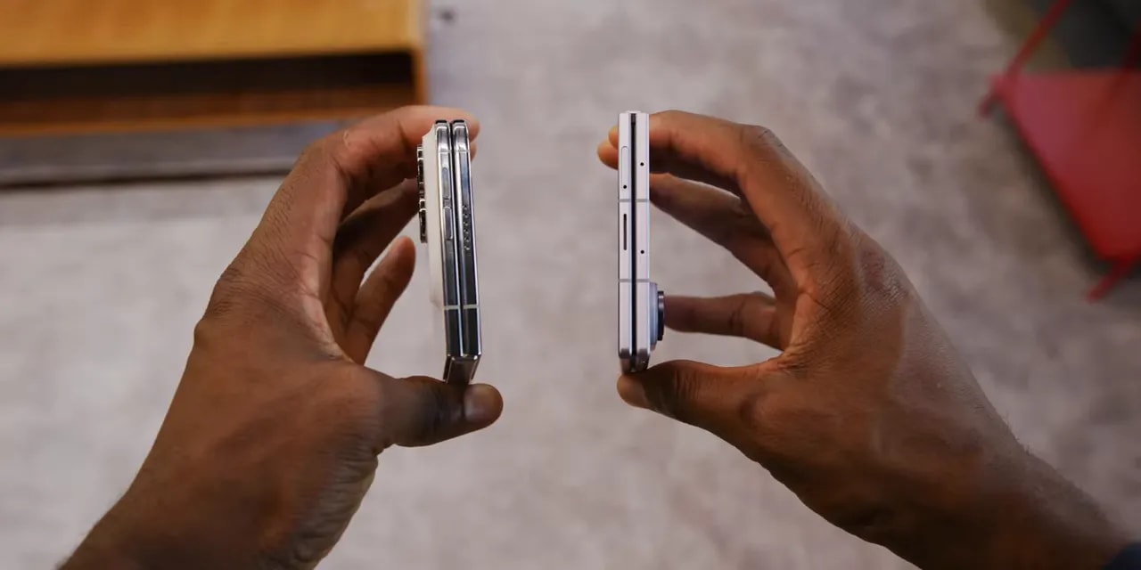 Two folded phones held side by side with their edges facing the camera