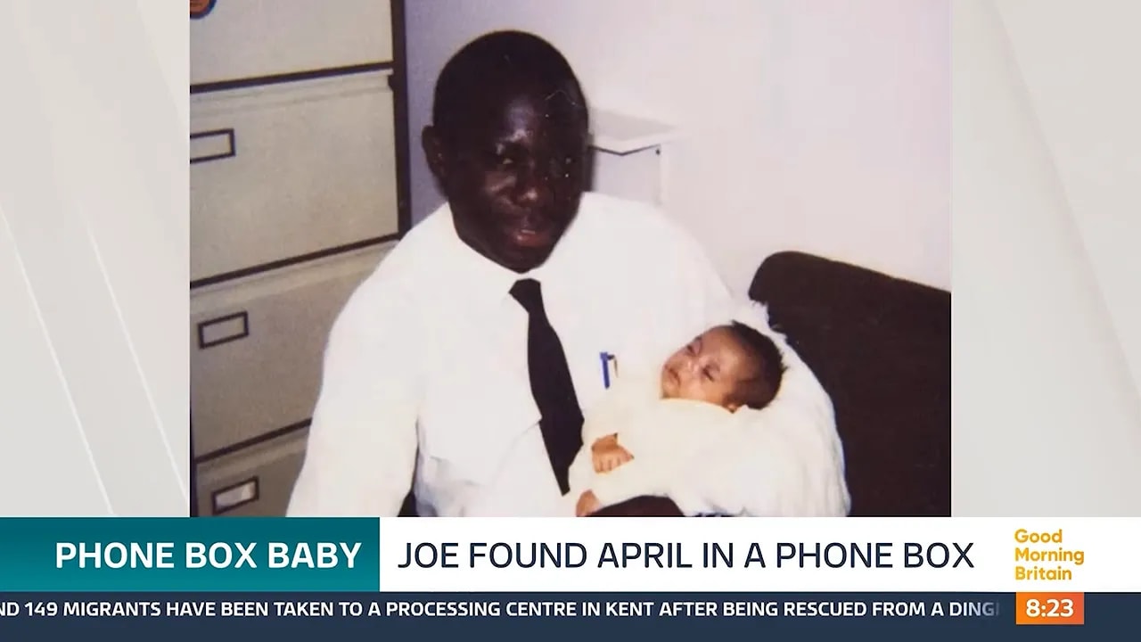 Archival photograph of Joe Campbell holding a newborn baby